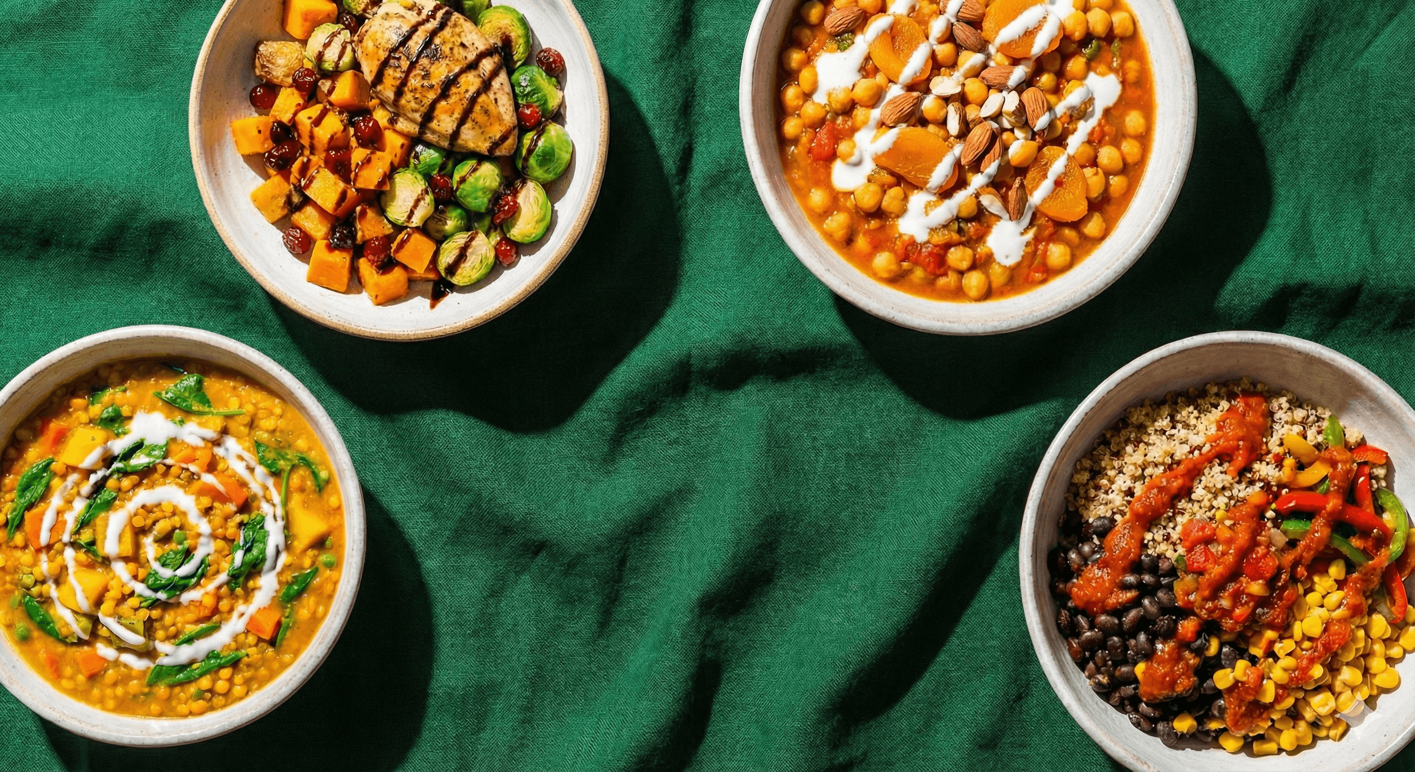 A photo of a woman eating a salad at sunset.